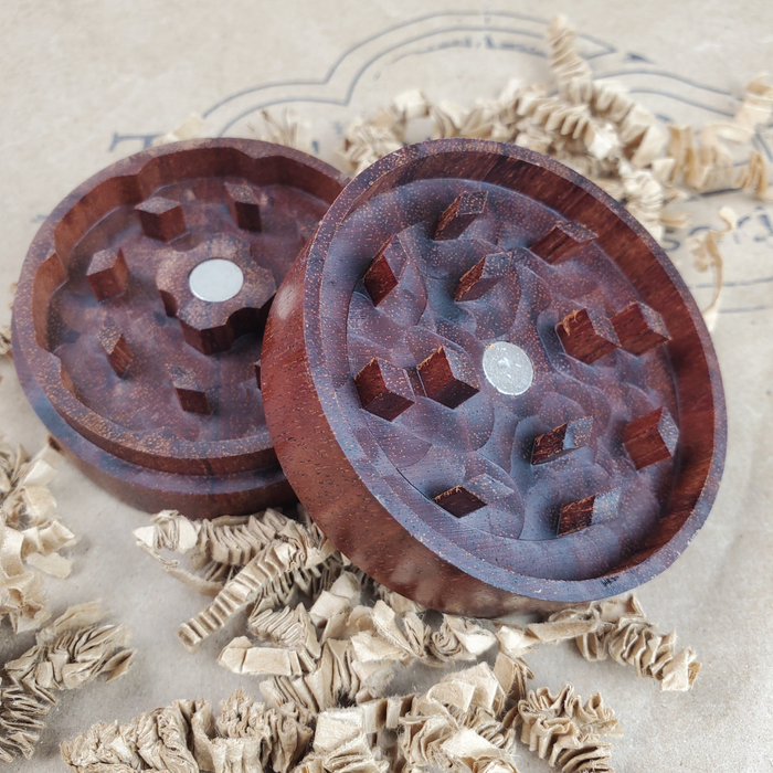 SAPELE WOOD HERB GRINDER WITH CLOUD LOGO ON CRINKLE PAPER AND THE 9TH CLOUD CANNABIS ACCESSORIES SHIP LOGO BACKGROUND