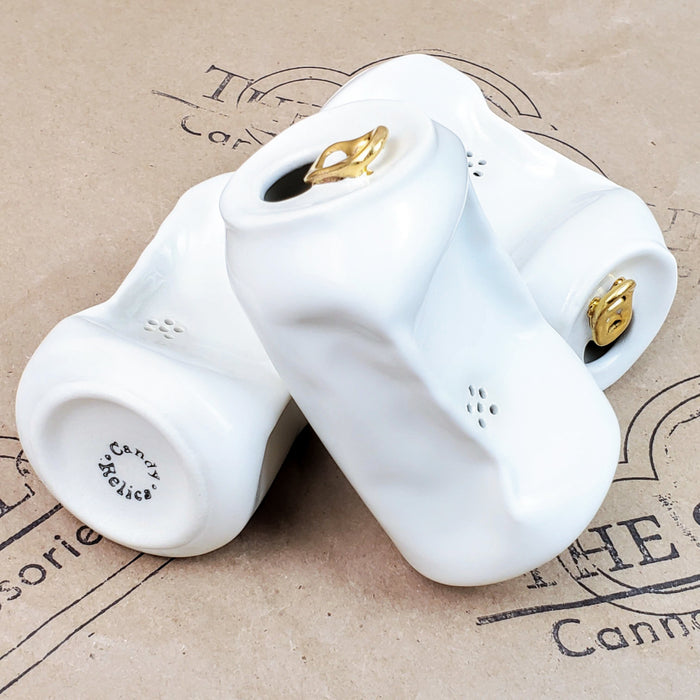 WHITE CERAMIC PIPE THAT LOOKS LIKE A POP CAN WITH GOLD TAB ON A 9TH CLOUD CANNABIS ACCESSORIES LOGO BACKGROUND