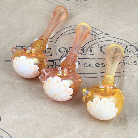GLASS PIPE WITH PEACH FLOWER PEDAL DESIGN ON THE 9TH CLOUD CANNABIS ACCESSORIES SHOP LOGO BACKGROUND